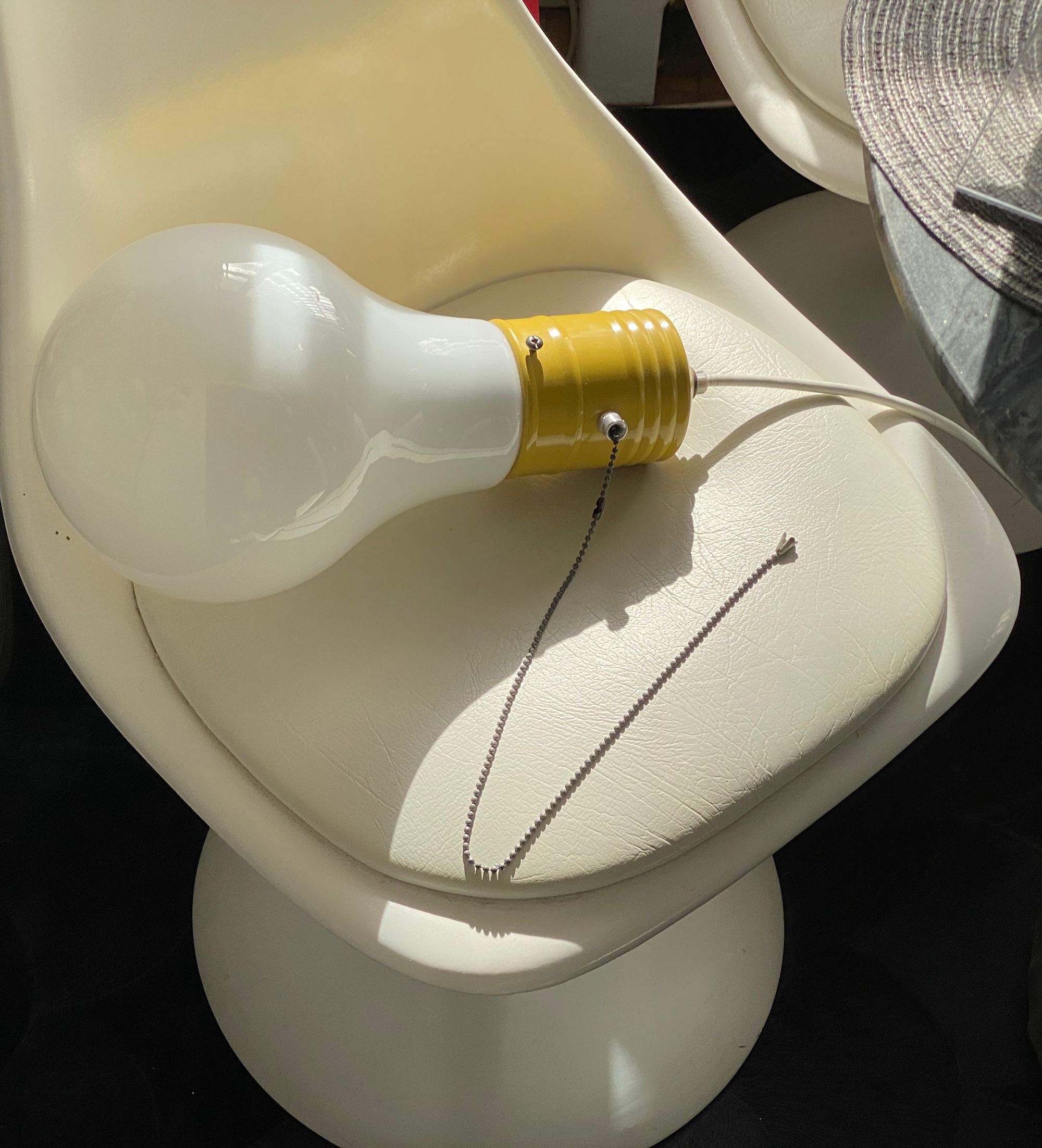 Lightbulb lamp resting on a dining chair