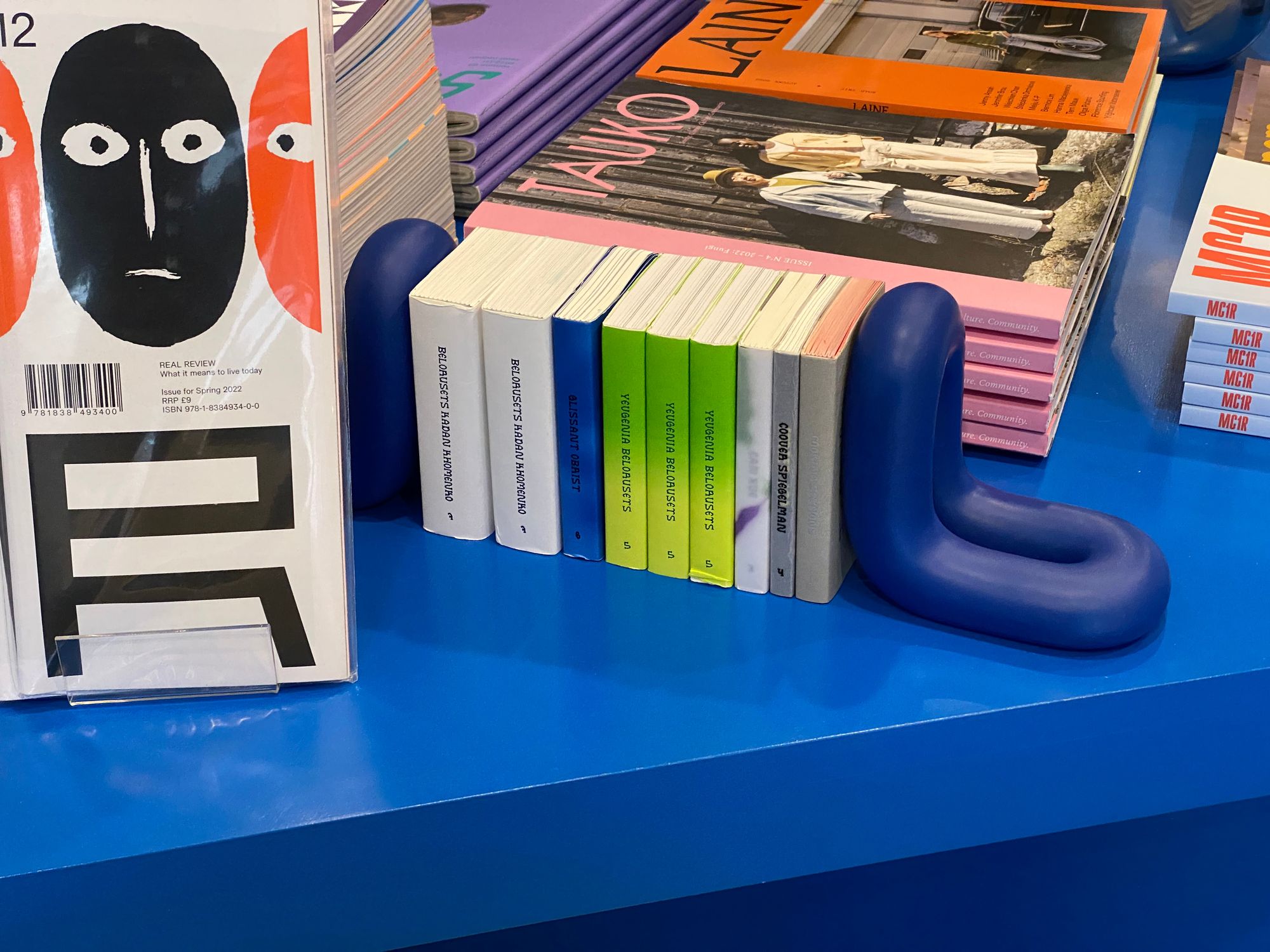 Miniature magazines on a bright blue table