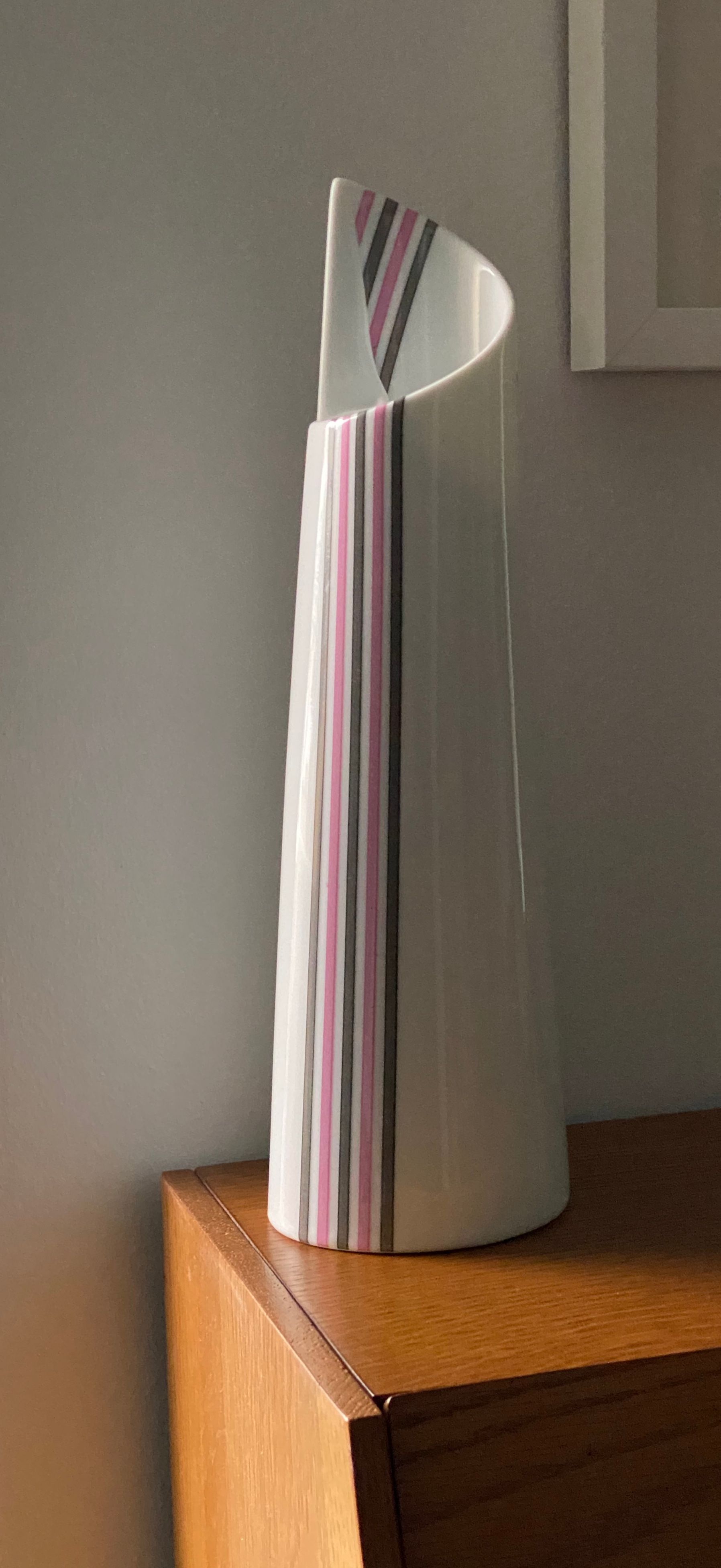 Japanese vase with vertical grey and pink stripes.