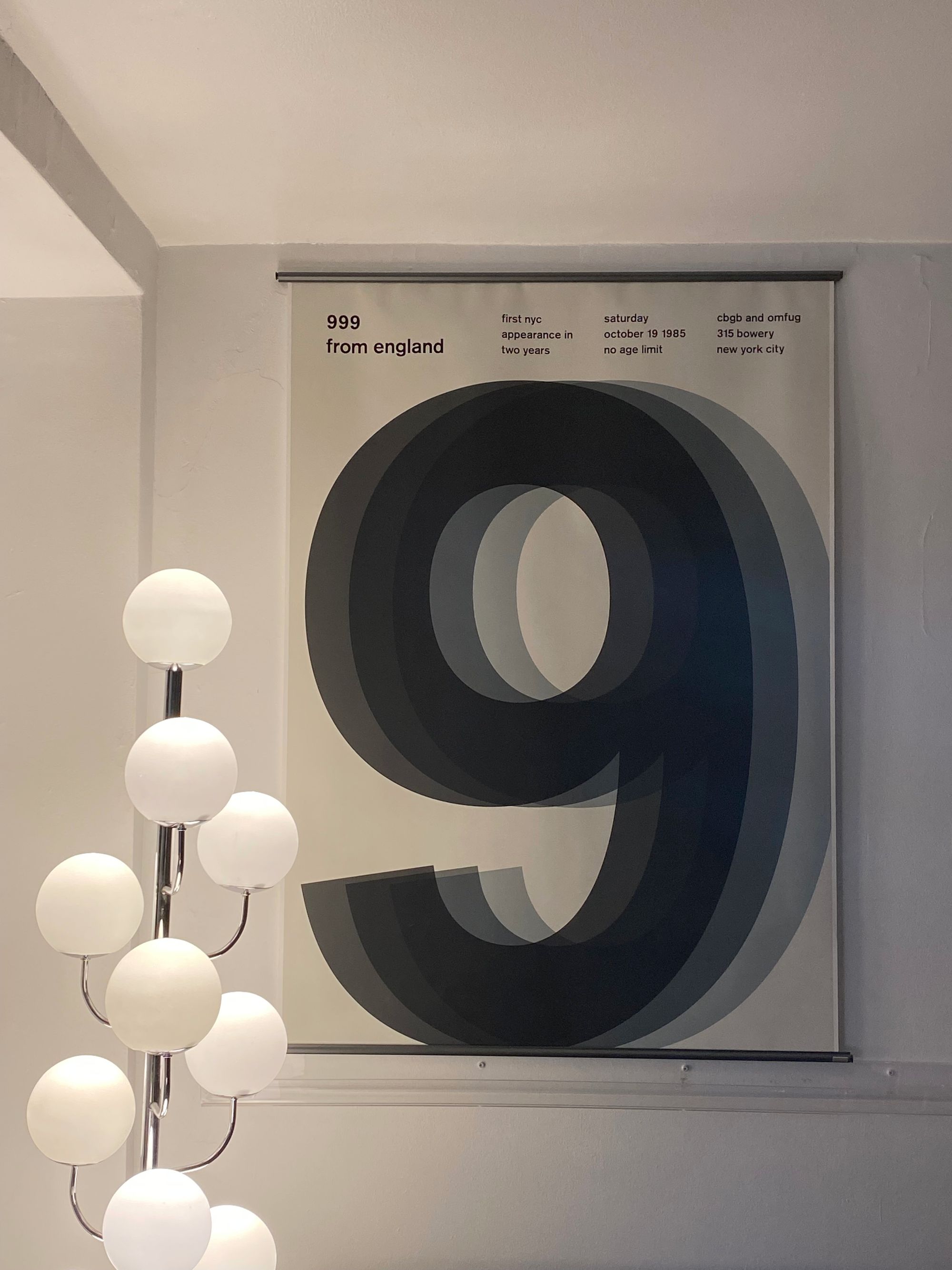 Large poster with three overlapping number nines.