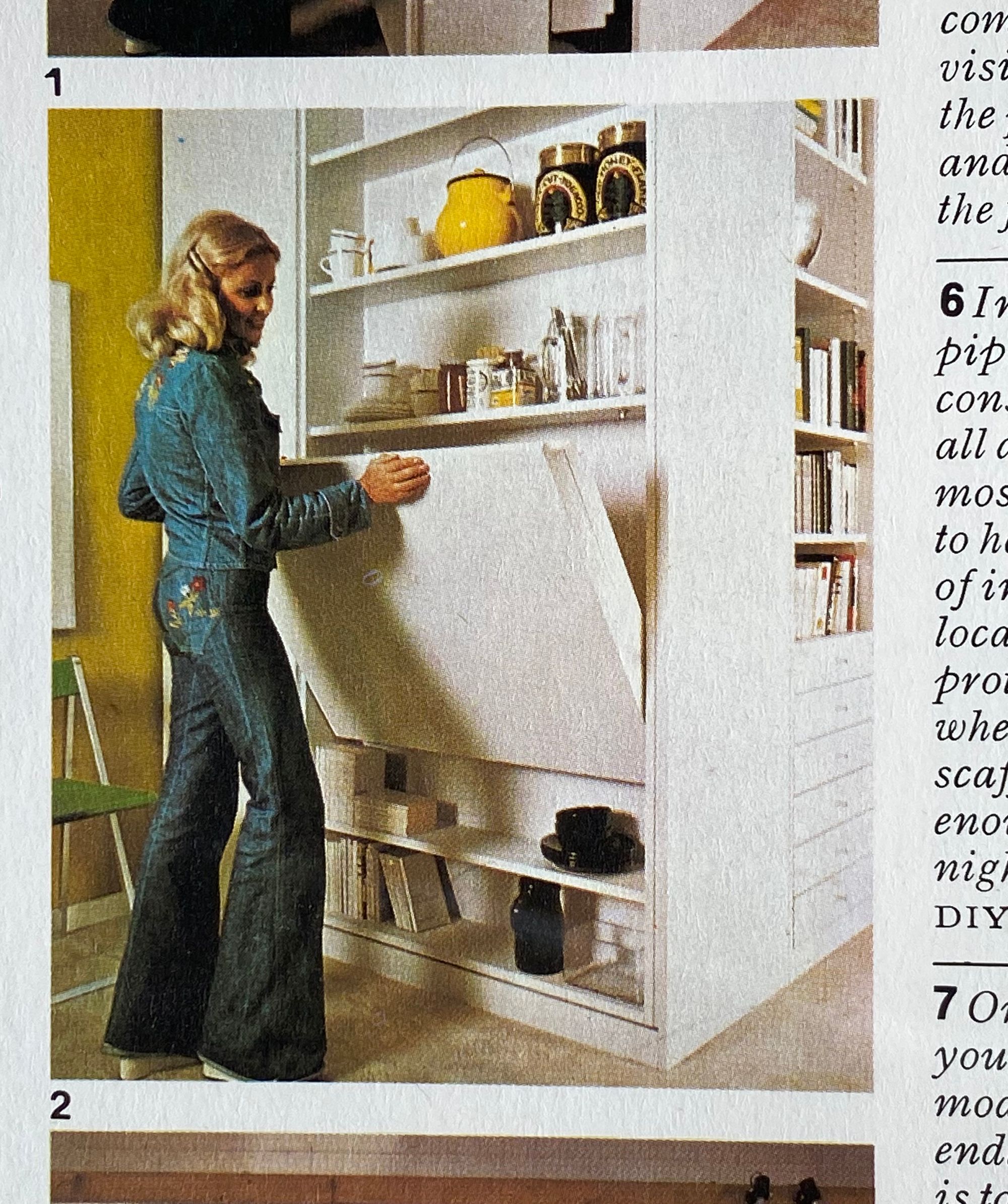 Woman demonstrating a wall unit's fold-out table.