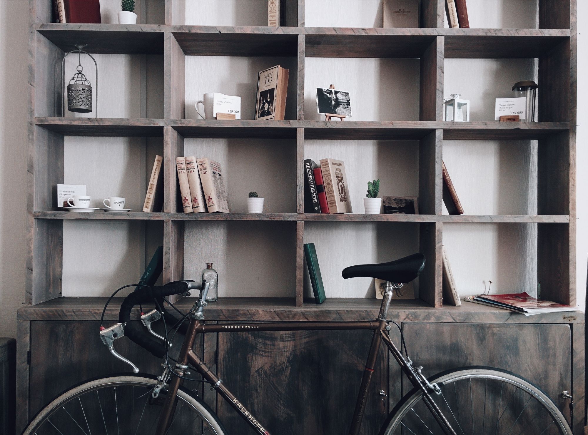 Books and decorative objects on display in a large wooden wall unit