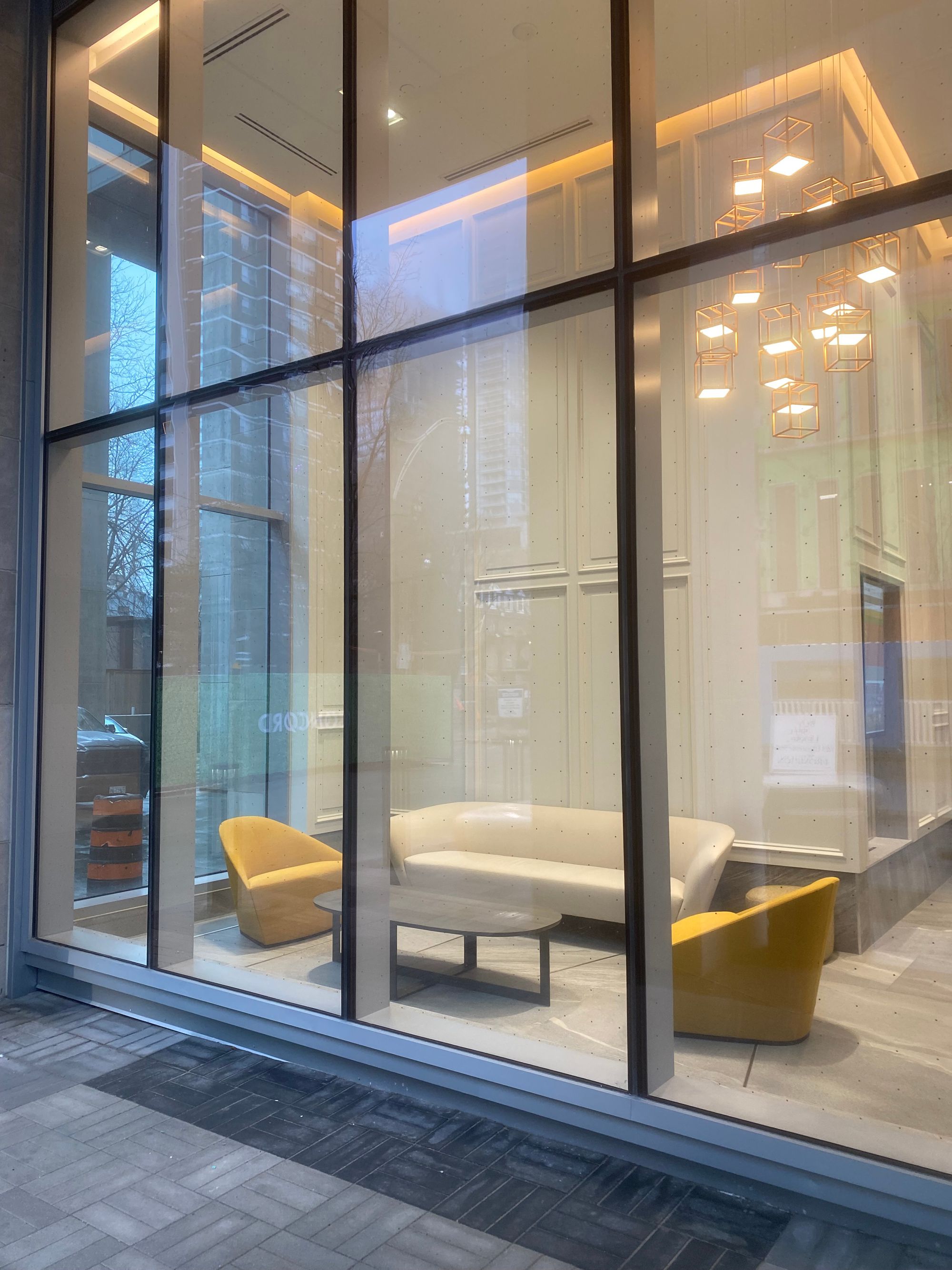 Elegant living room arrangement seen through floor-to-ceiling windows