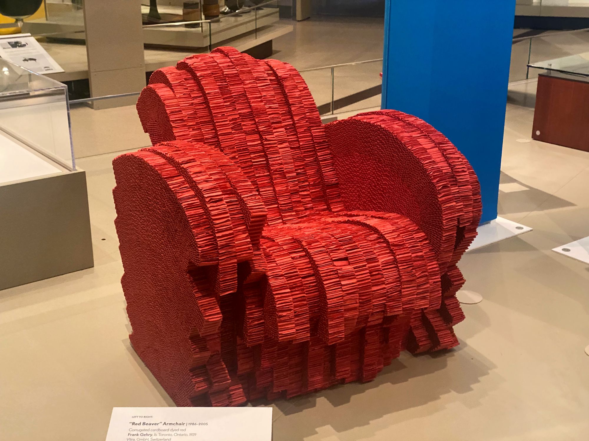 Armchair made of bright red, sculpted cardboard.