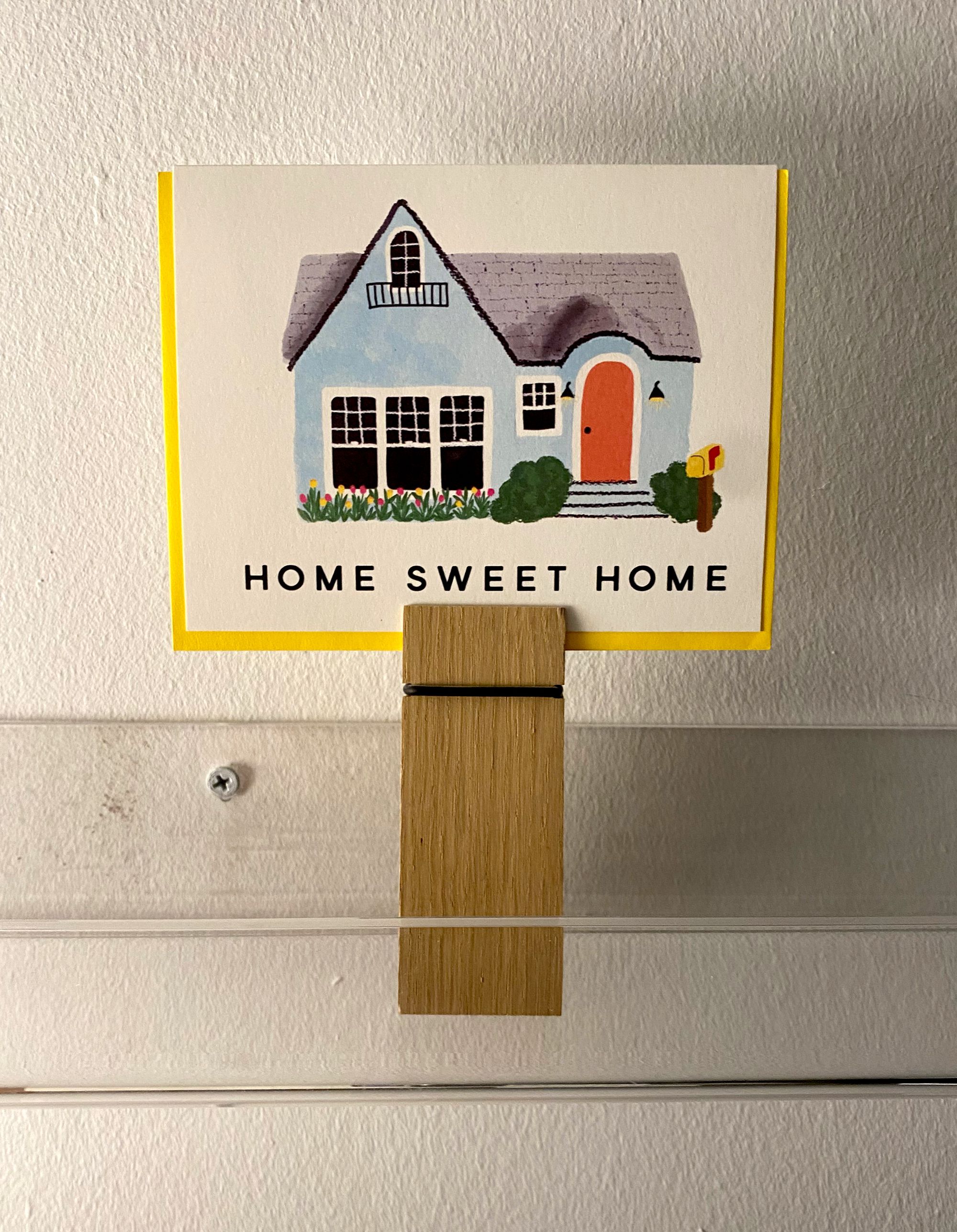 Greeting card with an illustration of a house and the words HOME SWEET HOME.