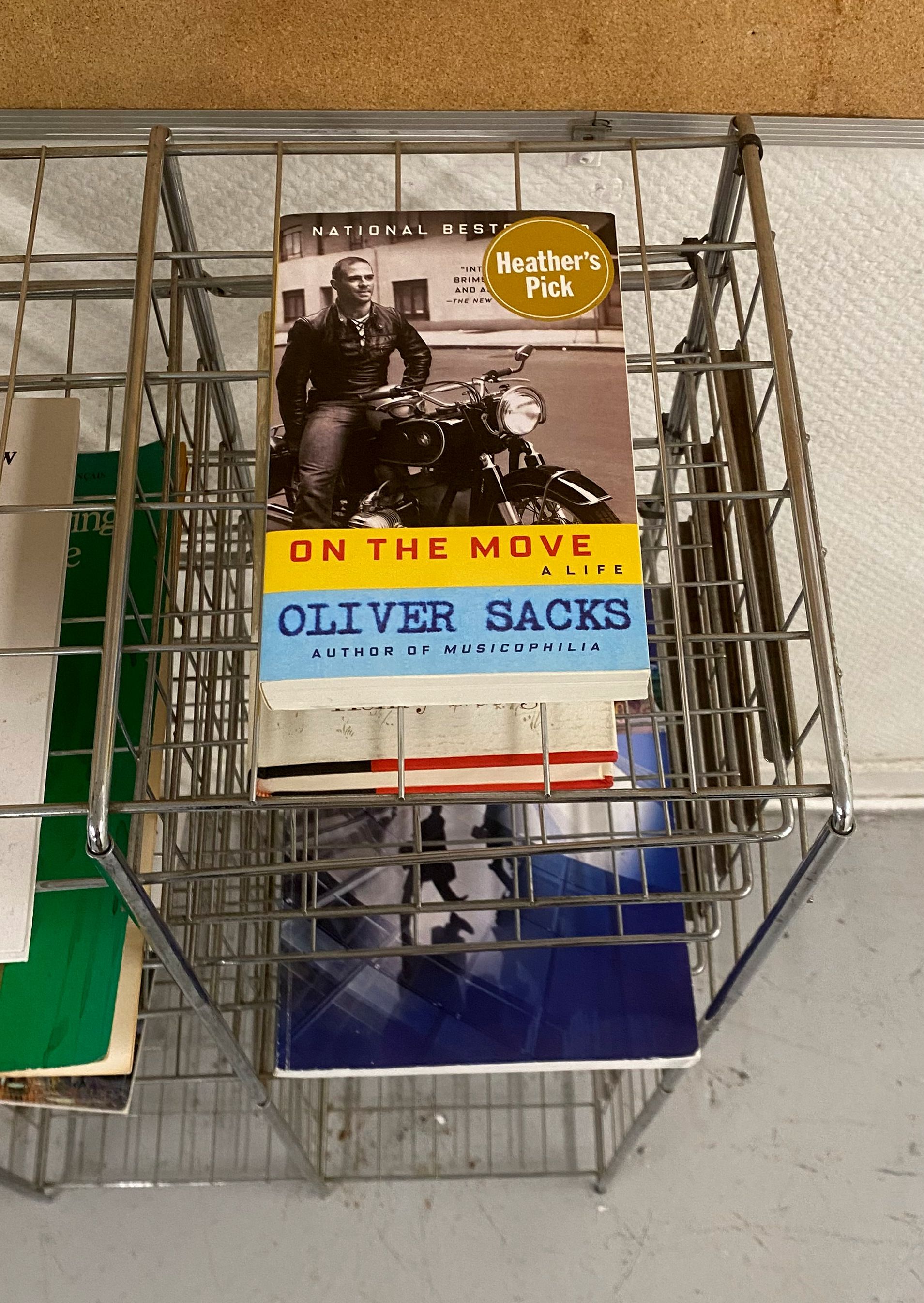 "On the Move" by Oliver Sacks on a metal shelving unit.