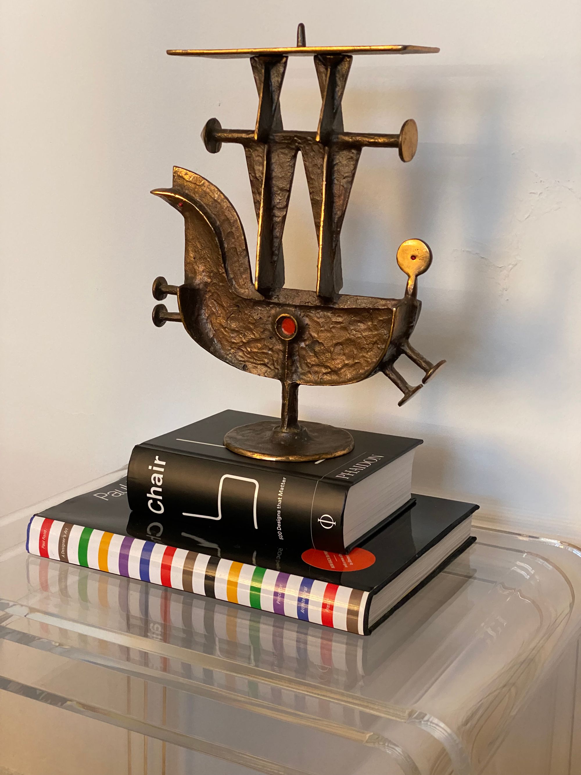 Horse sculpture resting on a stack of two books.