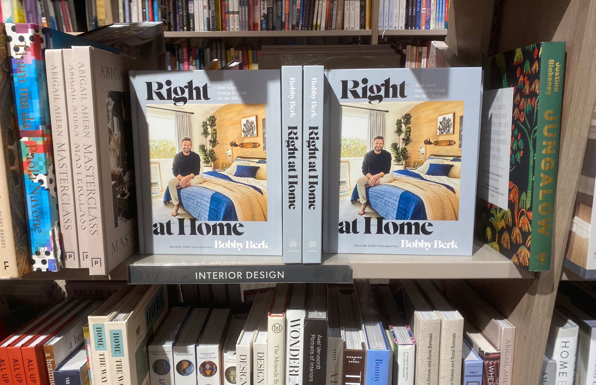 Shelves of interior design books at Indigo, with copies of "Right at Home" by Bobby Berk taking up lots of space.