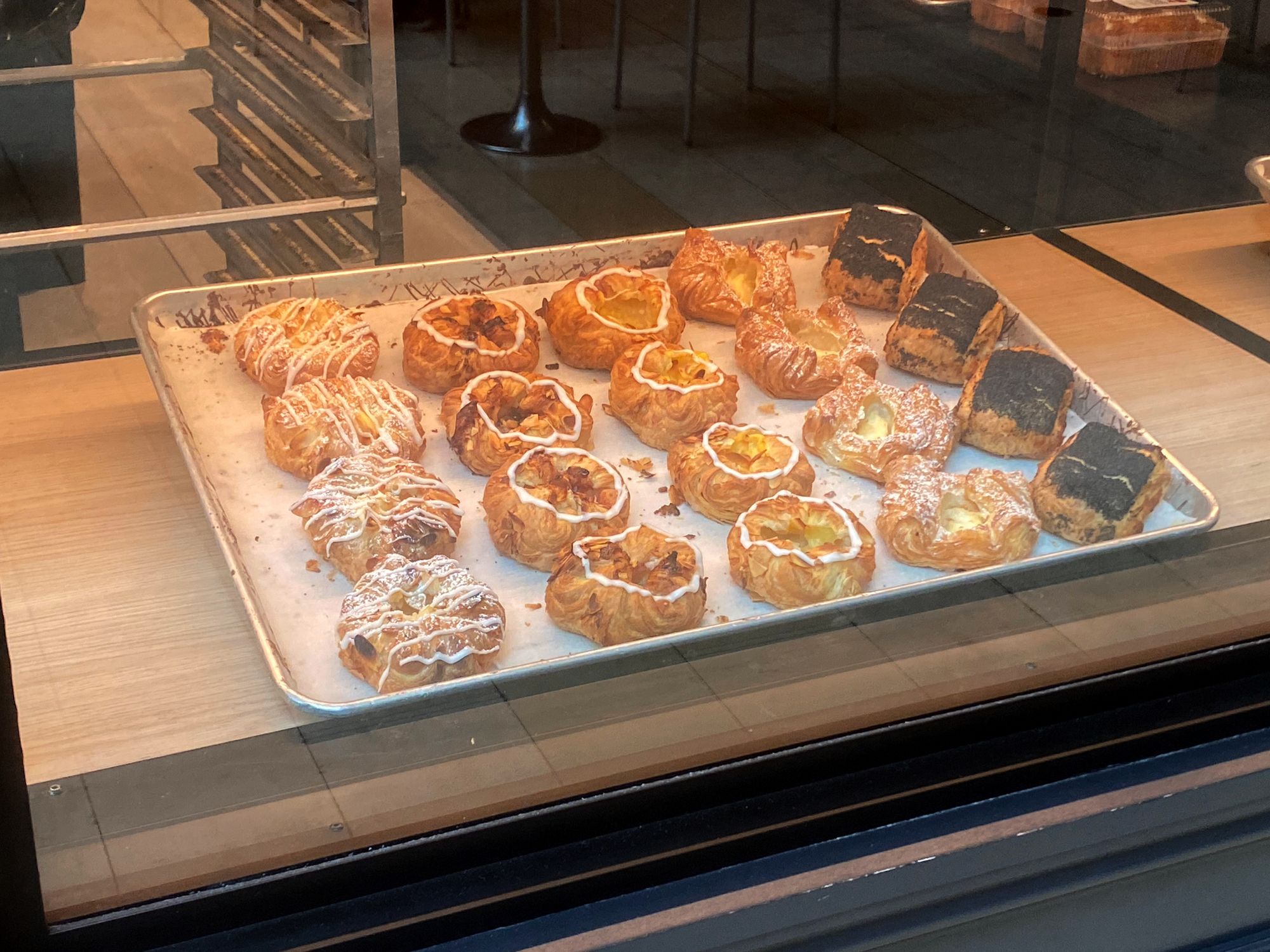 Tray of 20 Danish pastries neatly organized in rows.