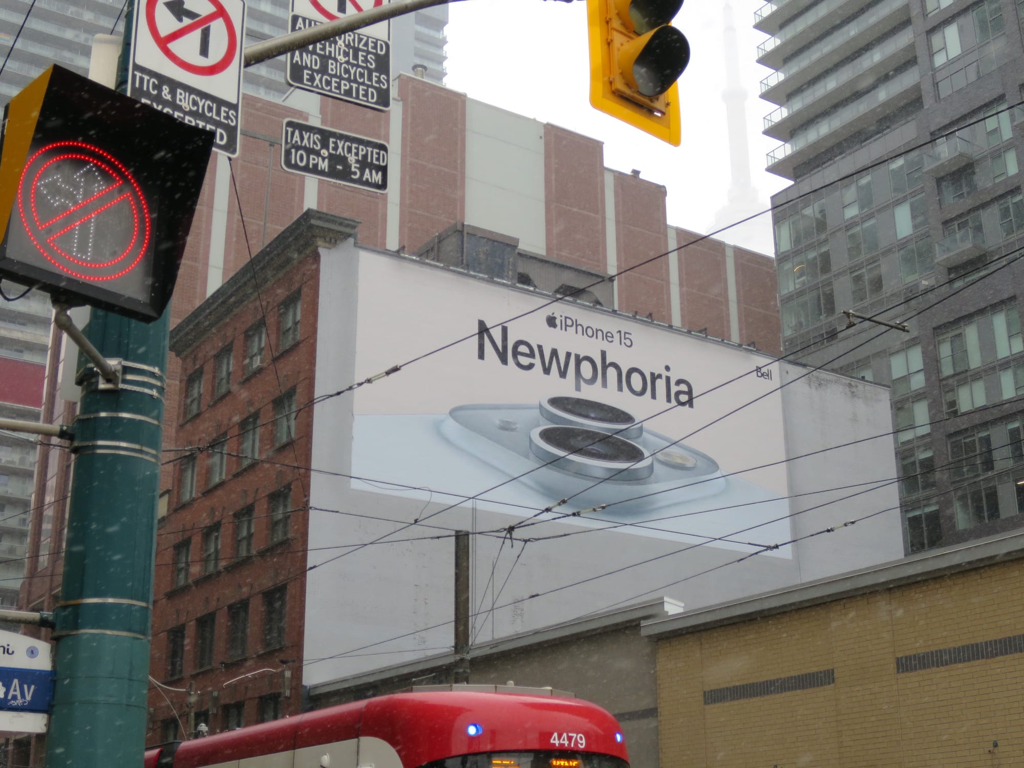 Billboard for iPhone 15 with an extreme closeup of the phone's camera lenses and the tagline "Newphoria."