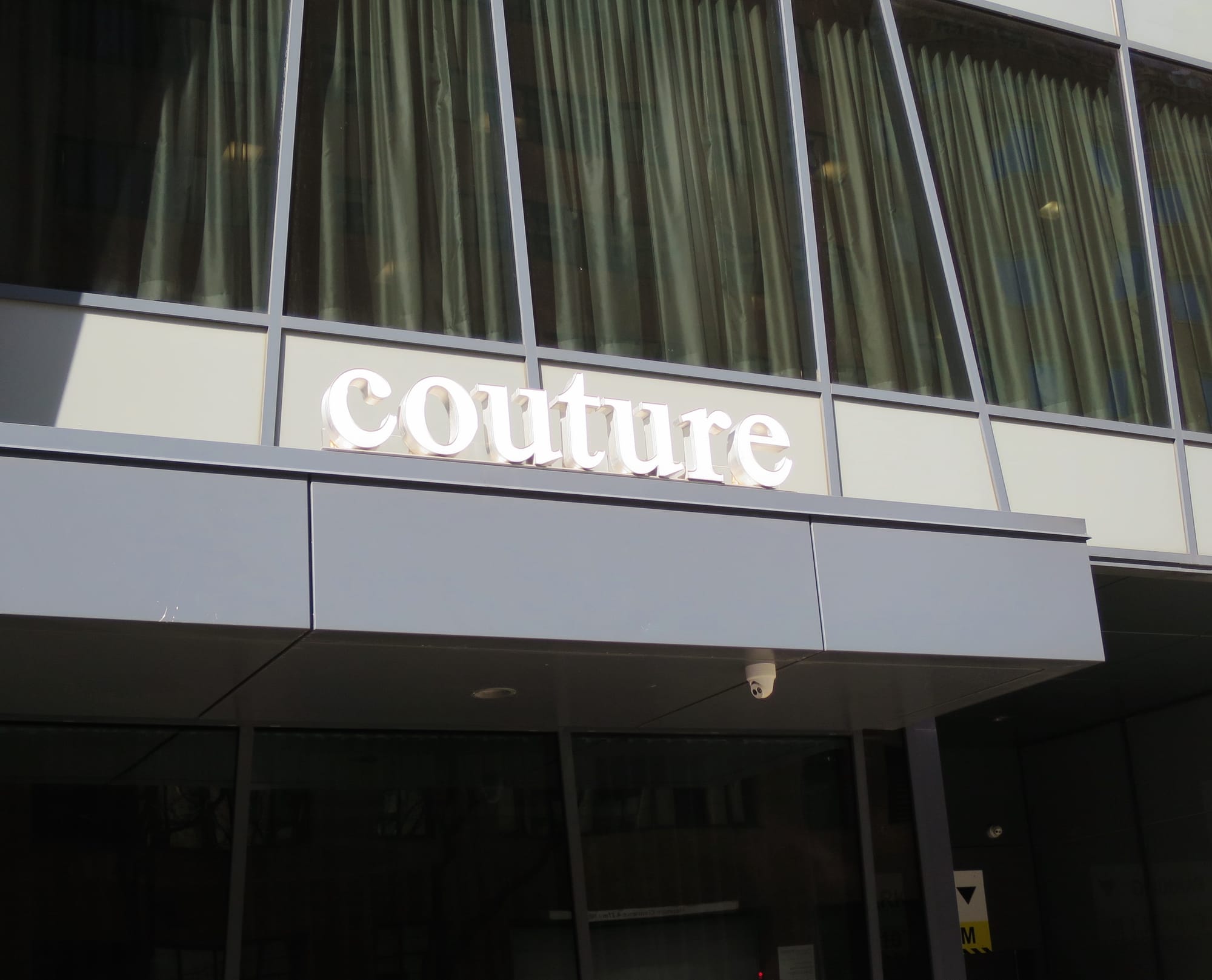 Condo entrance with the word "couture" above it.