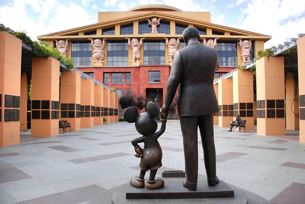 Disney building, with a sculpture of Walt Disney and Mickey Mouse holding hands in the foreground.