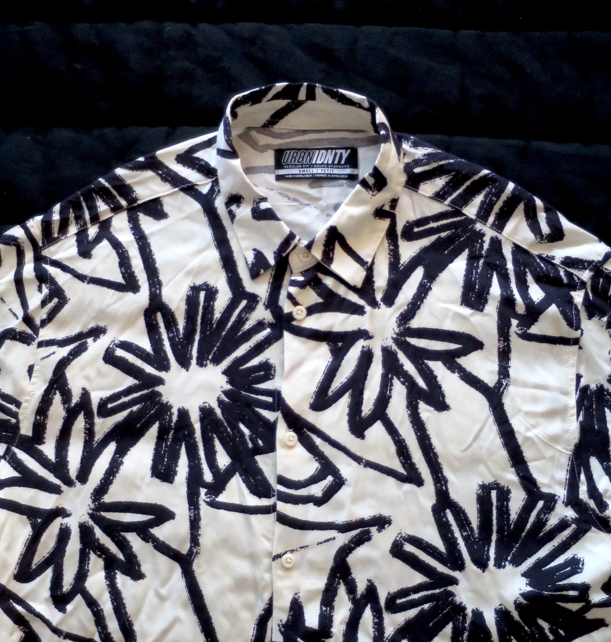 Summer shirt with pattern of bold black lines against a white background.