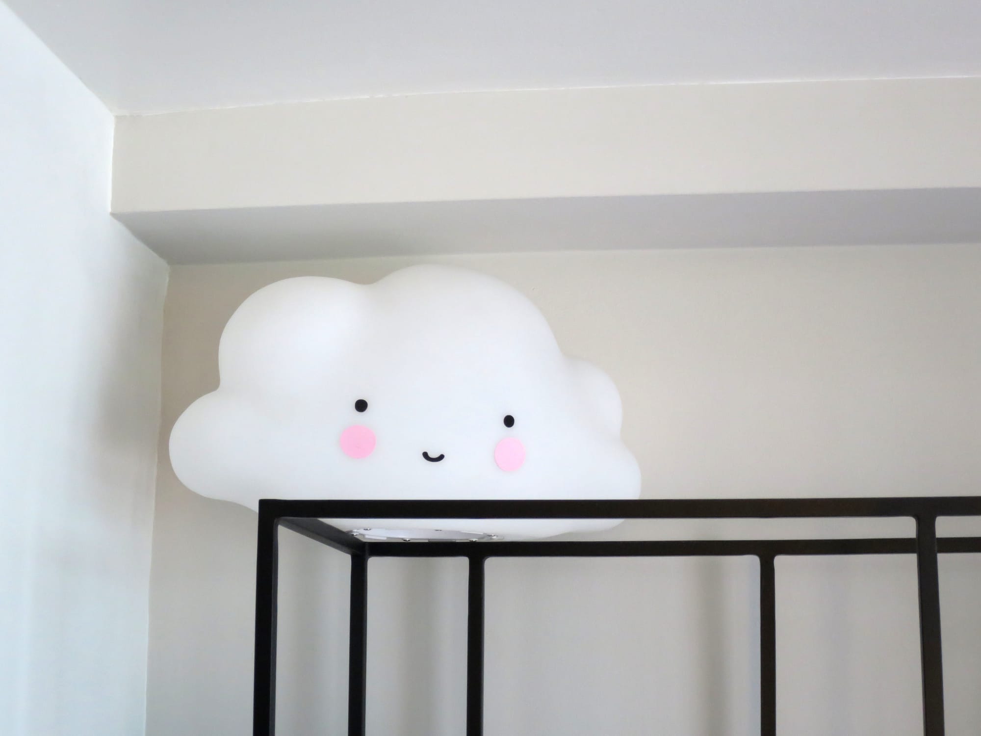 Light in the shape of a stylized cloud, resting on top of a display unit.