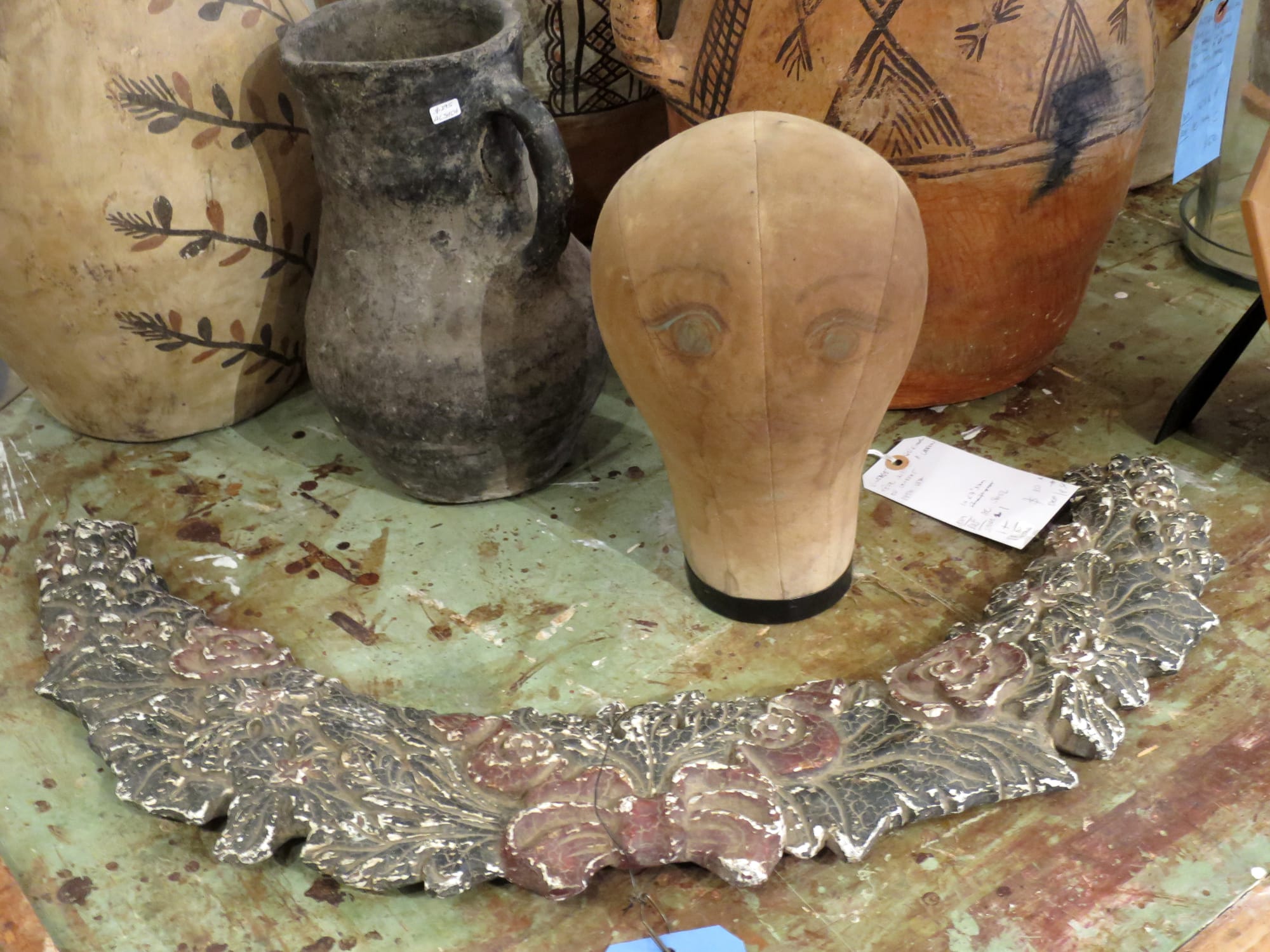 Hatmaker's dummy on a tabletop with other vintage objects