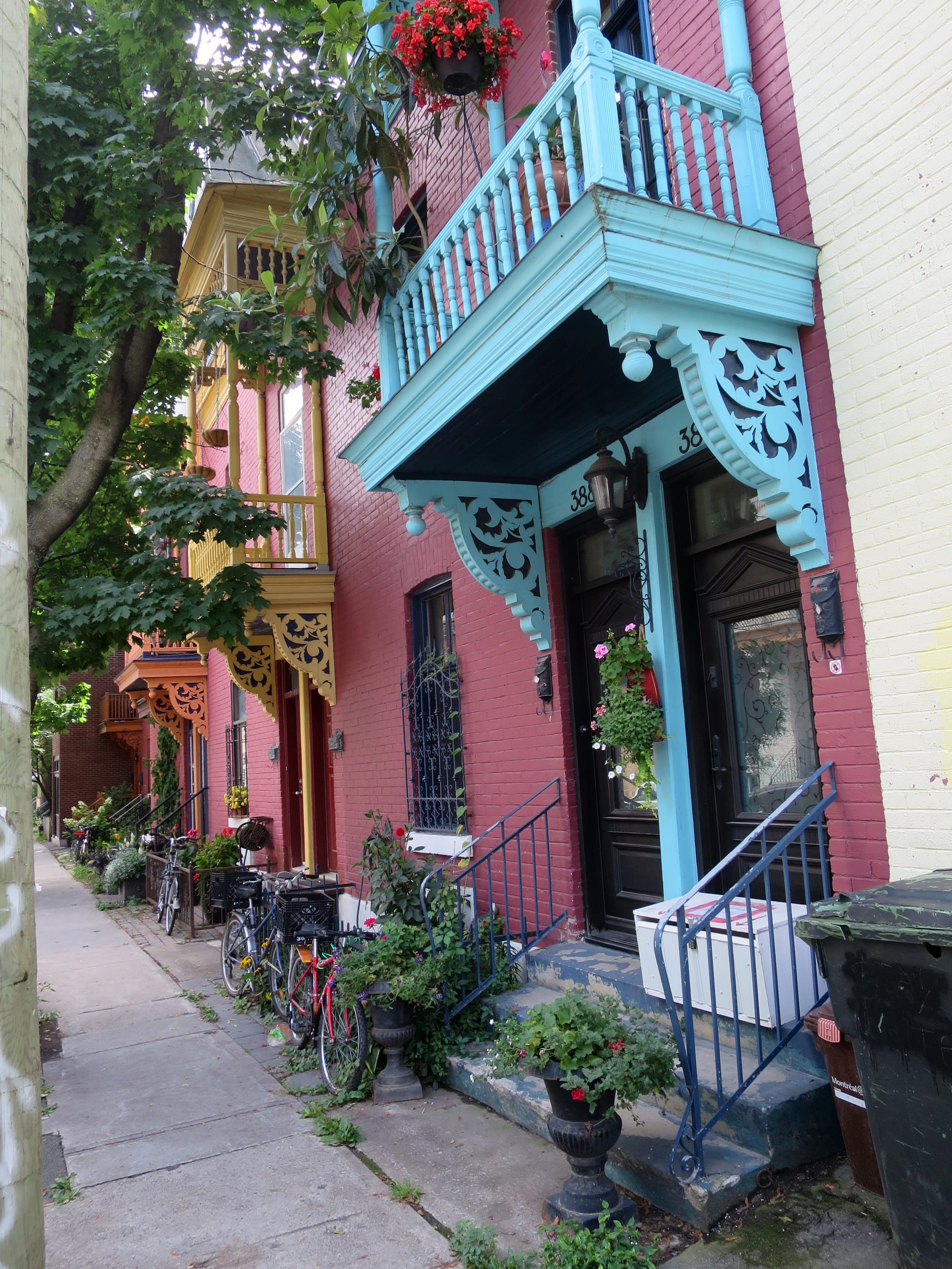 Another street with identical moldings above the entrances, painted different colours.