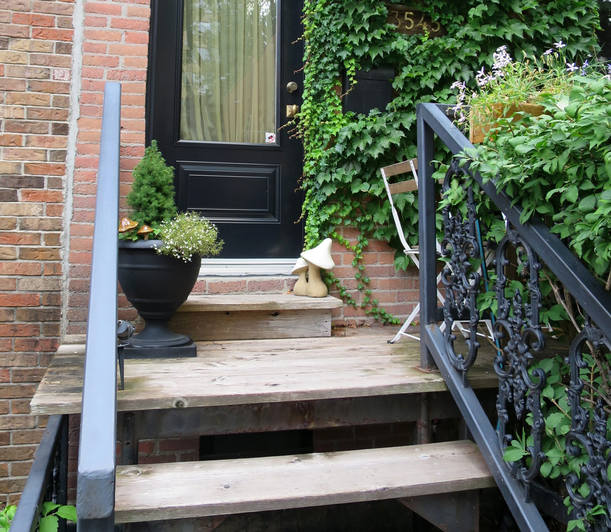 Ceramic mushrooms decorating the porch in front of an entrance.