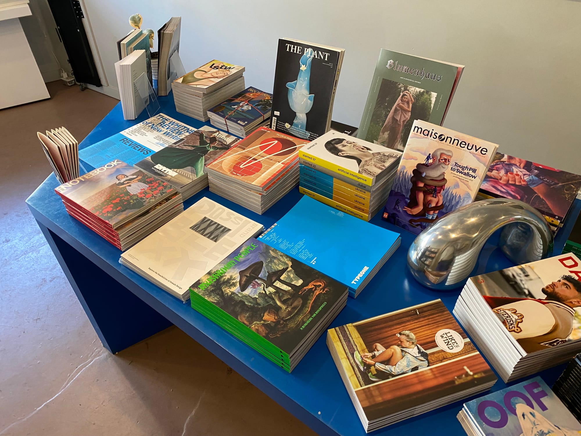 Table inside Issues featuring stacks of magazines.