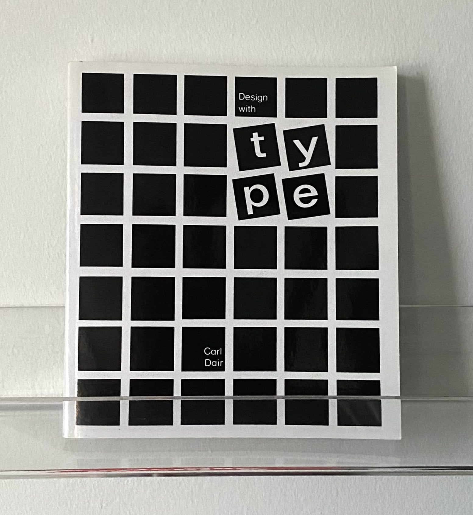 "Design with type" book, with a grid of black squares, four of which are tilted.