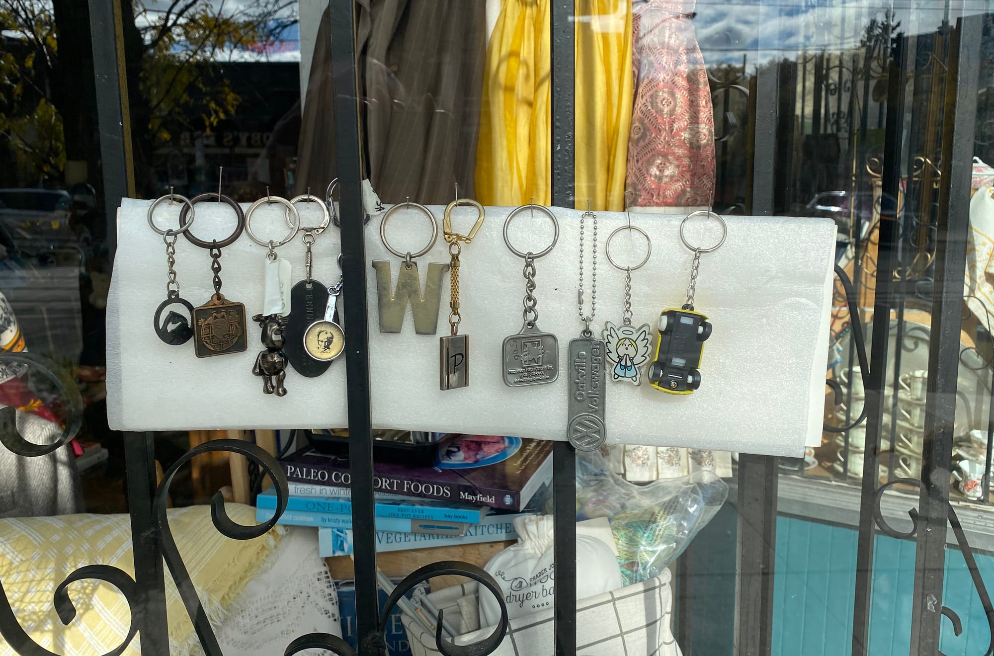 Eleven keychains in a row, each with a different fob.