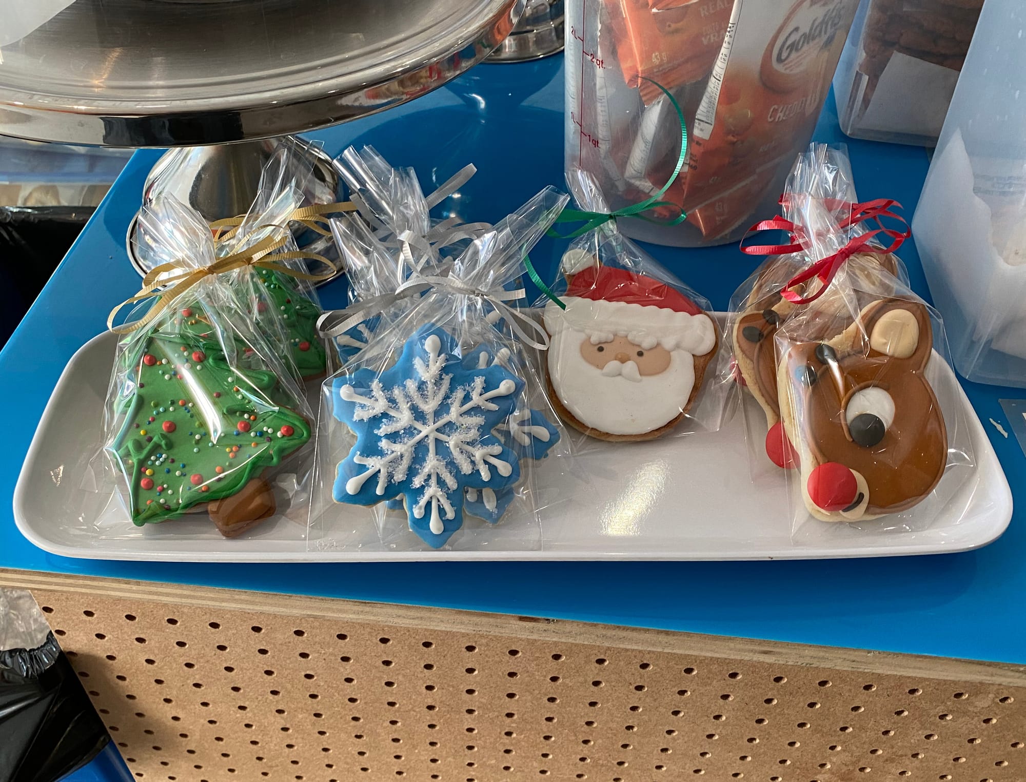 Cookies decorated with Christmas imagery, including the face of Santa and of Rudolph the Red-nosed Reindeer.