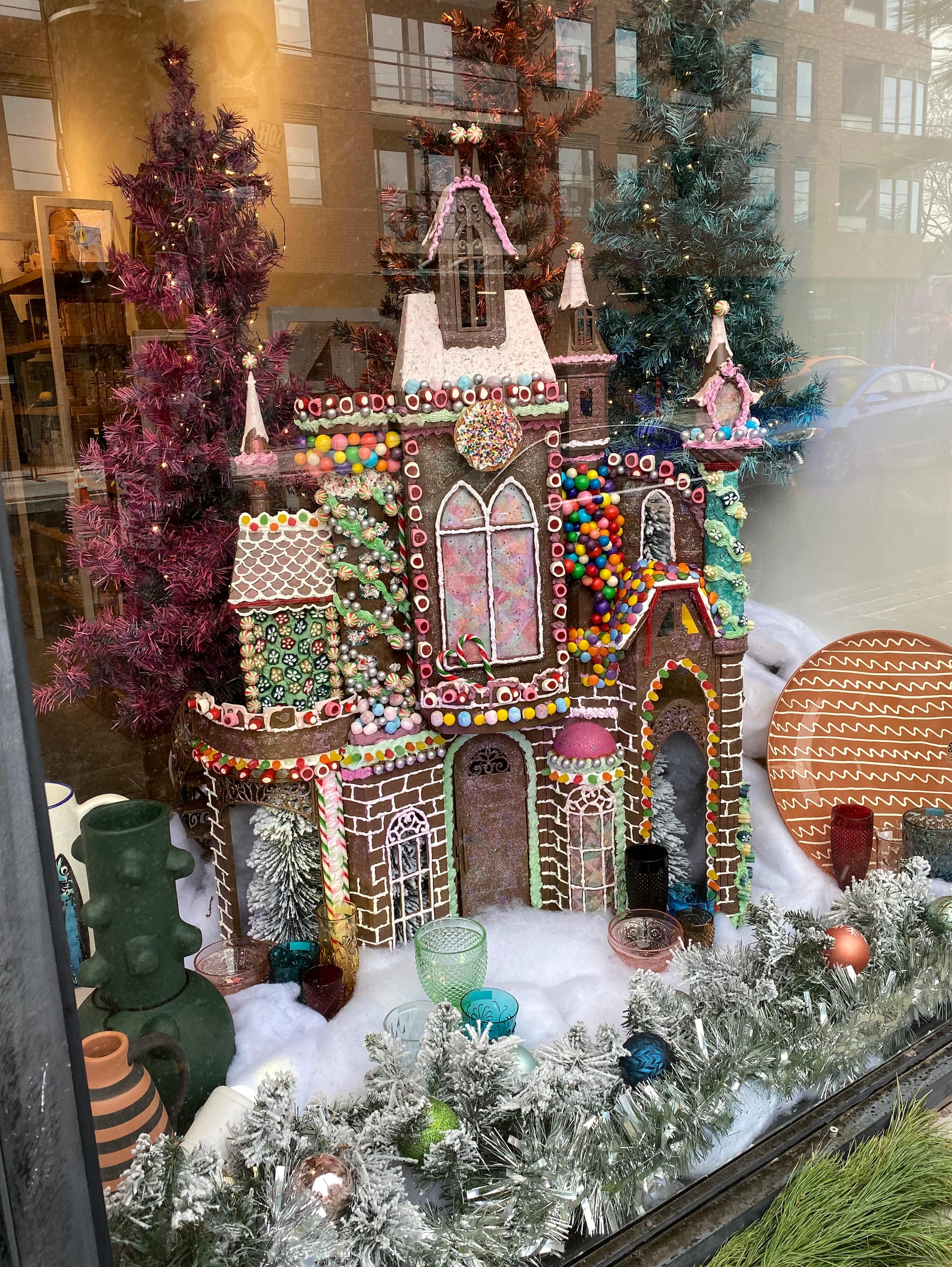 Large gingerbread house in shop window.