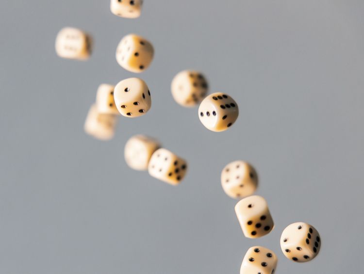 Large number of dice falling in mid-air.