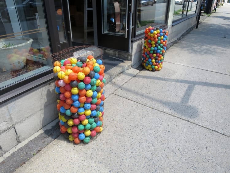 Containers of colourful balls, one on each side of the Style Labo entrance