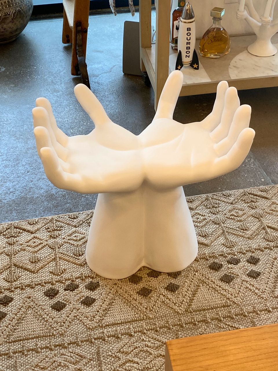 Ceramic stool made of two hands with palms upward