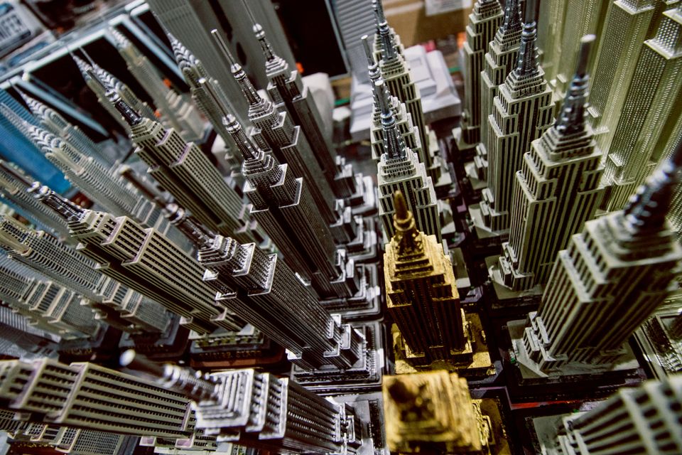 Close-up of a shelf full of toy-sized versions of classic New York City skyscrapers.