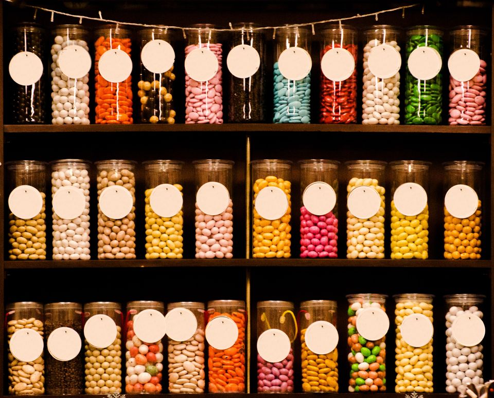 Shelves of glass containers filled with candy.