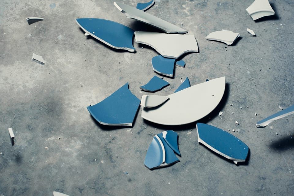 Small, shattered pieces of blue ceramic.